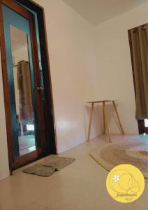 a room with an open door and a table at Kalachuchi Place by Aman Sinaya in General Luna