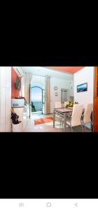 a kitchen and dining room with a table and chairs at Ferriere Apartment in Scala