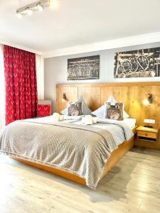 ein Schlafzimmer mit einem Bett mit zwei Hunden auf den Kissen in der Unterkunft Bergsonne B15 Montana Haus in Oberstdorf + 35 Fotos