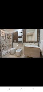 a bathroom with two sinks and two toilets at Ferriere Apartment in Scala