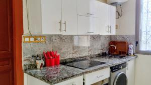 Una cocina con gabinetes blancos y encimera. en Appartement Néoclassique centre -ville, en Casablanca 18 fotos más