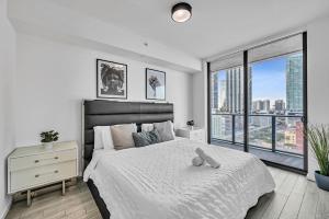 a bedroom with a large bed and a large window at Waterline Corner Vies 2Br 2BA Suites in Miami +29 photos