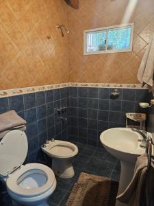 a bathroom with a toilet and a sink at La piezita in Ciudad Lujan de Cuyo +33 photos