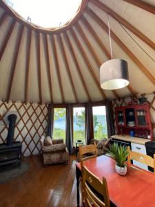 a dining room with a yurt with a table at Yourte Forêt des Murmures in Sacré-Coeur-Saguenay
