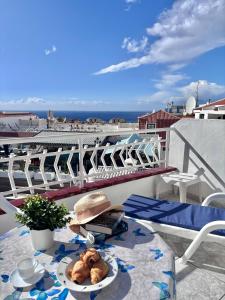 a table with a plate of food on a balcony at Cindy Golden Bay SeaView Terrace in El Guincho