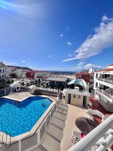 a view of a swimming pool on top of a building at Cindy Golden Bay SeaView Terrace in El Guincho