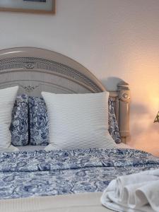a bed with blue and white sheets and pillows at Cindy Golden Bay SeaView Terrace in El Guincho +79 photos