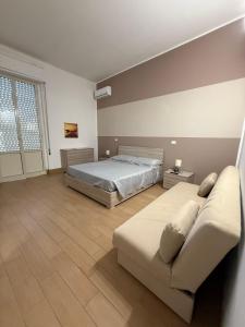 a large bedroom with a bed and a couch at Case Vacanze nonna Elisa in Avola +75 photos
