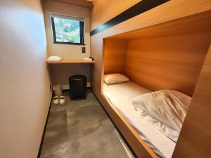 a small room with a bed and a window at Fukuchiya in Fujiyoshida +53 photos