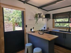 a kitchen with a counter top and a window at Luxury Unit with Mountain Views & Splash Pool in Oudtshoorn