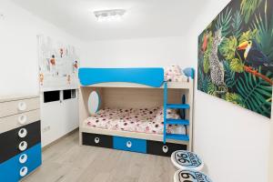 a bedroom with a bunk bed with a blue bunk bed at apartamento sevilla enzo in Seville