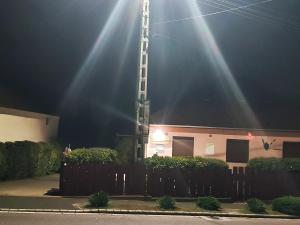 a church steeple with a beam of light on it at Vár-Liget Vendégház in Kisnána