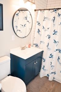 a bathroom with a blue and white sink and a toilet at The Salty Lime in Emerald Isle