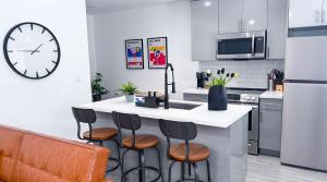 een keuken met een grote klok aan de muur bij The Hideaway - Wilton Manors in Fort Lauderdale