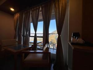 a living room with a large window with a view at Dwaper Palace A Luxury Property Near Library Chowk, Mussoorie in Mussoorie