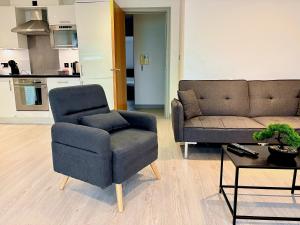 a living room with a chair and a couch at Modern 2 Bed Apartment in York City Centre - Best York Location - Steps from Top Attractions in York