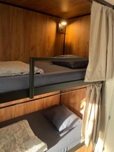 two bunk beds in a wooden cabin with at Downtown River Hostel in Donostia-San Sebastián