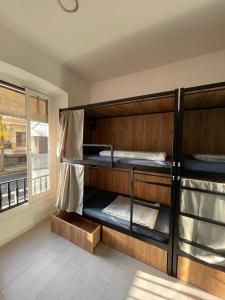 a room with bunk beds with a window at Downtown River Hostel in Donostia-San Sebastián +24 photos
