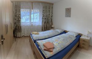 Кровать или кровати в номере Residenz Darianne Leukerbad