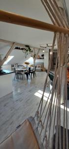 Małopolskie Swojskie في Olszyny: غرفة بها طاولات وكراسي وأرجوحة