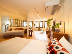 a bedroom with two beds and a living room at お宿Ｇａｎ福田町-Luxury Stay-駐車場無料 in Takamatsu