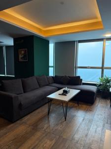 a living room with a couch and a coffee table at 2Bed Apartment in Centaurus with City and Margalla views in Islamabad