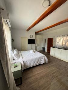a bedroom with a large white bed and a table at The Uptown studio in Lusaka +11 photos