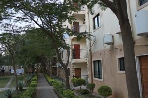 an apartment building with trees in front of it at The Uptown studio in Lusaka