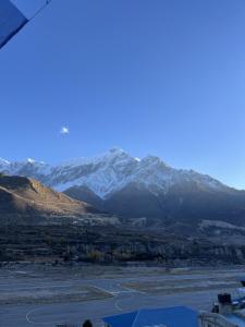 a view of a mountain range with snow covered mountains at Hotel mustang in Jomsom