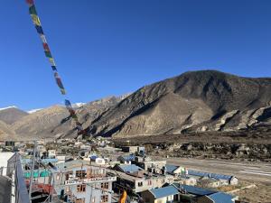 a view of a city with a mountain in the background at Hotel mustang in Jomsom