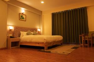 a bedroom with a bed and a large window at Hotel mustang in Jomsom