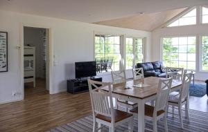 Beautiful Home In Bolmsö With Wifi في Bolmsö: غرفة طعام وغرفة معيشة مع طاولة وكراسي