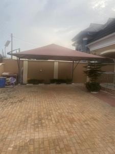 a building with a purple covering on top of it at Flexy Short-let in Sagamu