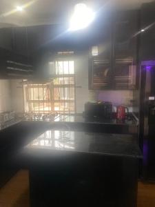 a kitchen with a table and chairs in a room at Flexy Short-let in Sagamu