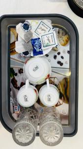 a suitcase filled with glasses and other items at devkritii innn stays in Faizābād