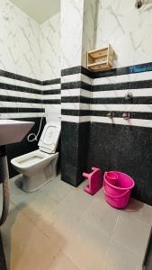 a bathroom with a toilet and a sink at devkritii innn stays in Faizābād