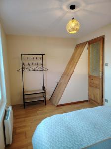 a bedroom with a bed and a wooden floor at Au sable fin in Grand-Fort-Philippe +32 photos