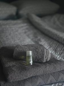 a small bottle sitting on top of a bed at Hotel & Restaurant Hasa in Gernrode - Harz