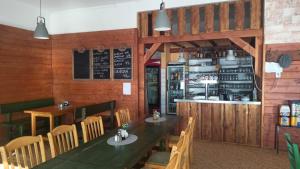a restaurant with a table and chairs and a bar at Chata v Lískách in Lísky