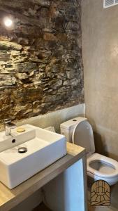 a bathroom with a sink and a toilet at Cap Hélios, Centuri in Morsiglia