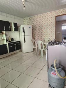 una cucina con frigorifero, tavolo e sedie di Casa Lins para 15 pessoas a Lins