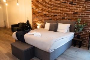 a bed in a room with a brick wall at Chic Brighton Studio in Brighton & Hove