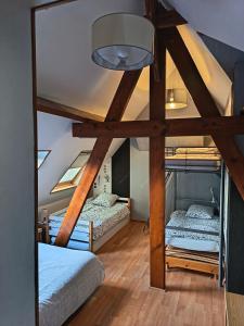 a bedroom with two bunk beds in a attic at La maison de Keralies in Pleumeur-Bodou