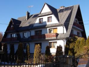 a large white house with a black roof at U Dany in Białka Tatrzanska