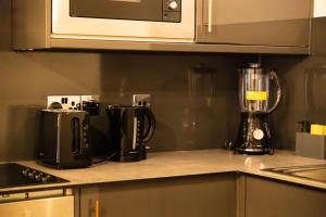 a kitchen counter with a blender on a counter top at Chic Brighton Studio in Brighton & Hove