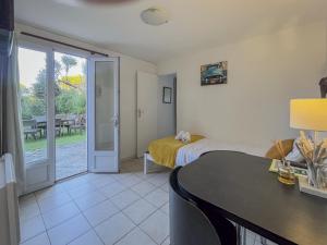 a bedroom with a bed and a table and a door at MY Tropézienne in Saint-Tropez
