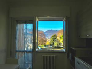 a window with a view of a mountain view at Lily House in Luino
