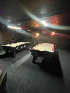 two ping pong tables in a room with a pool table at Forresters Bar & French Restaurant with Rooms in Middleton in Teesdale
