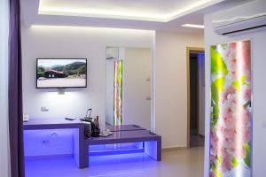 a bathroom with a purple table and a mirror at Hotel Christina Plus in Bucharest
