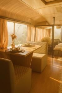a table with a wine glass on it in a rv at Refúgio Da Lua - Buss motorhome in Ametista do Sul